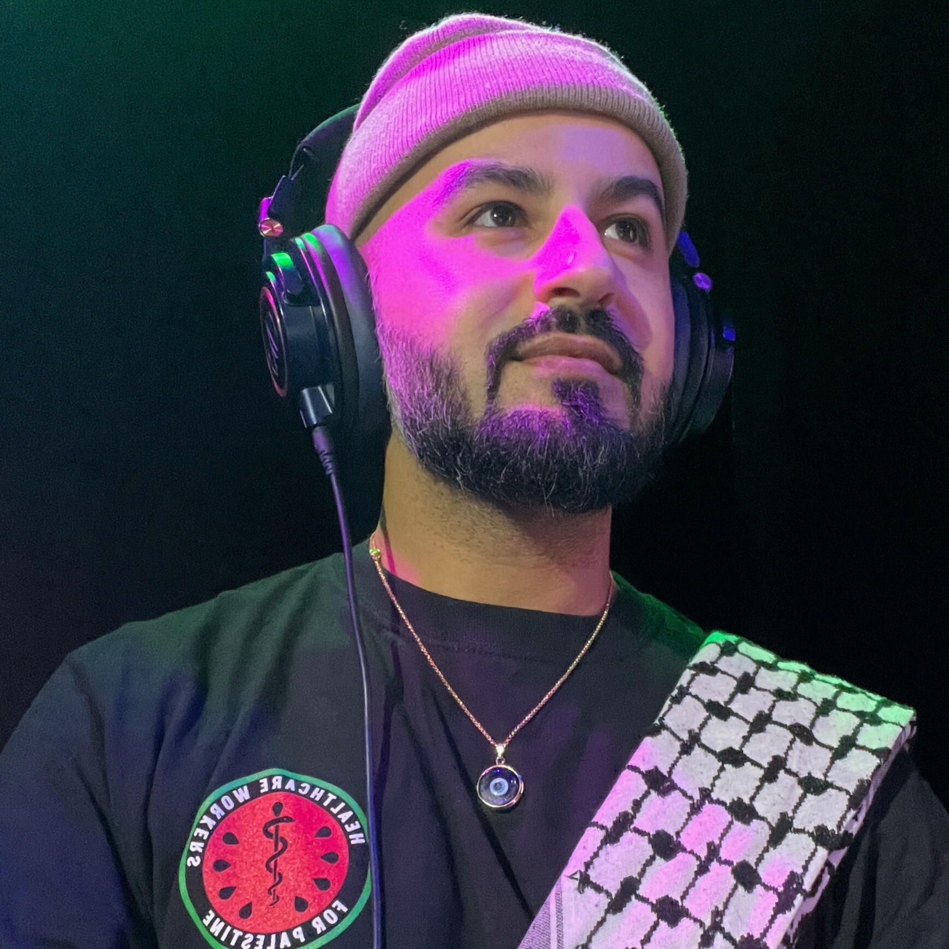 dark blue handmade turkish evil eye necklace modeled on DJ. lampwork glass evil eye framed in gold-plated stainless steal with gold-plated stainless steel chain.