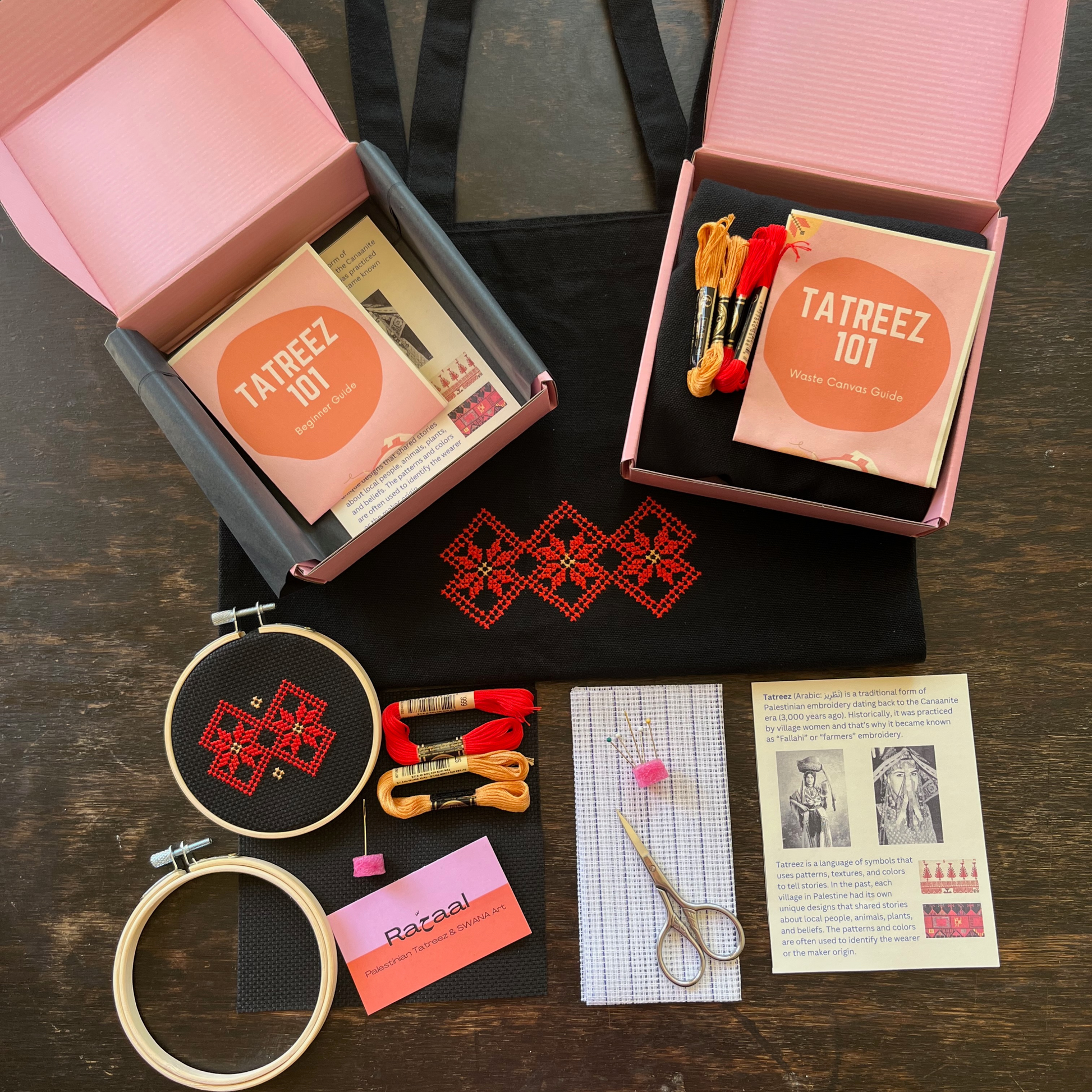 Tatreez tote bag kit with materials laid out, including black tote bag, tatreez instructions, black aida cloth, embroidery hoop, Ramallah Star Moon tatreez pattern, embroidery threads, embroidery needle and sewing pins, embroidery scissors, tatreez instructions for beginners, and waste canvas. view from above