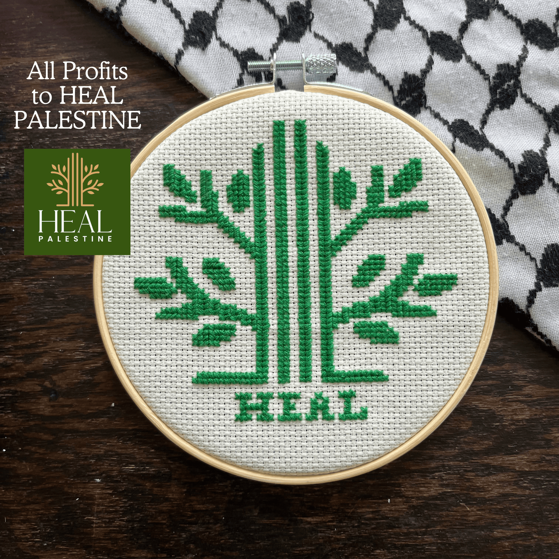 Tatreez kit with Palestinian olive tree design. white aida cloth, embroidery hoop, view from above