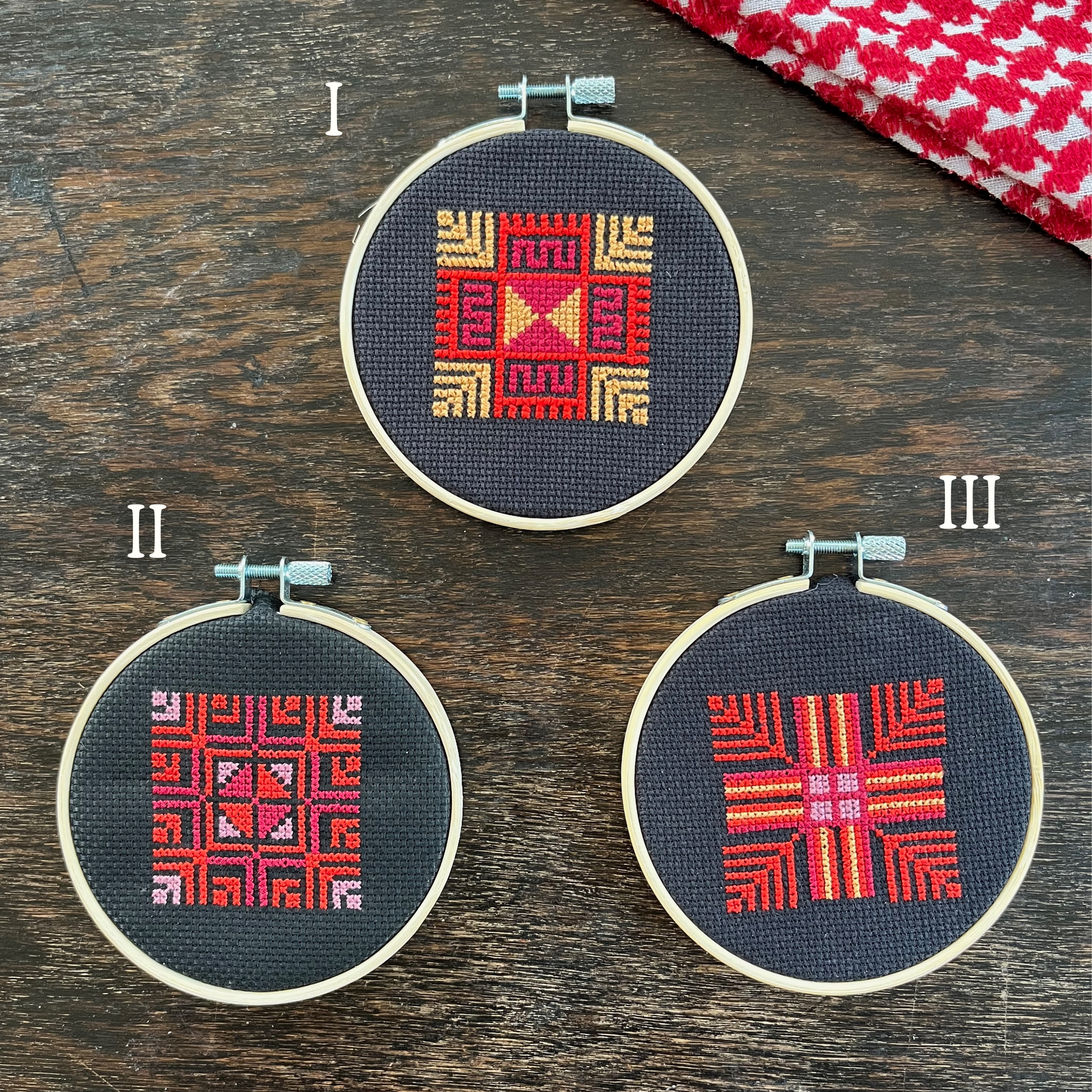 Tatreez kits with moon with feathers Palestinian tatreez designs. black aida cloths, embroidery hoops, view from above