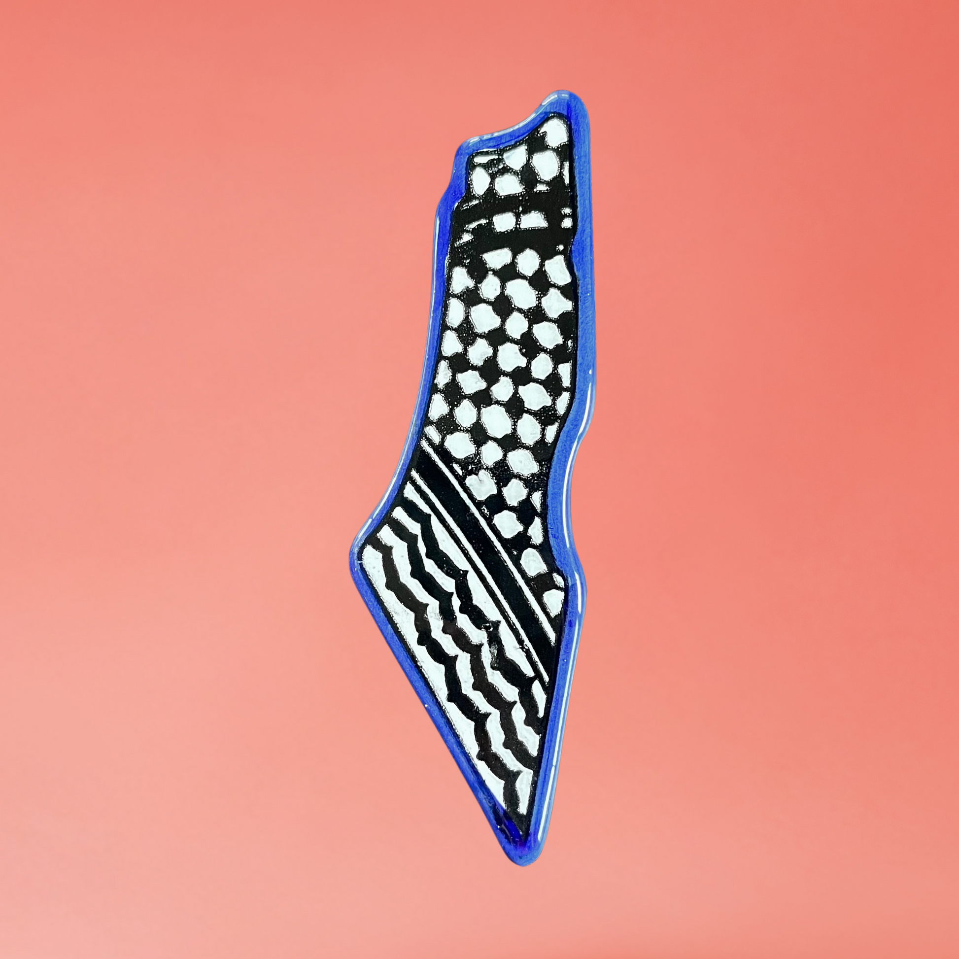 Ceramic Palestine map fridge magnet with blue kuffiyeh design. front view on pink background