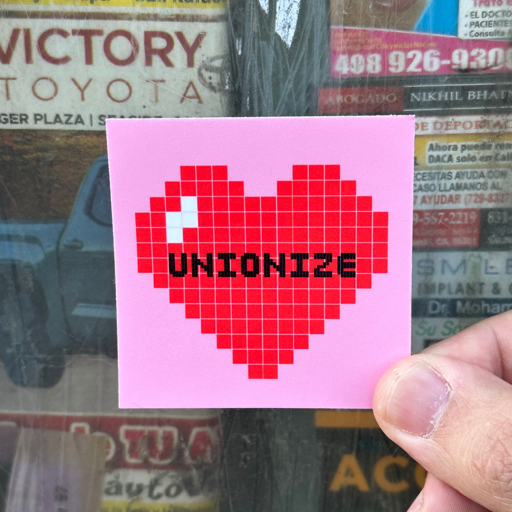 Pixelated heart with 'UNIONIZE' text on a pink background. socialist sticker