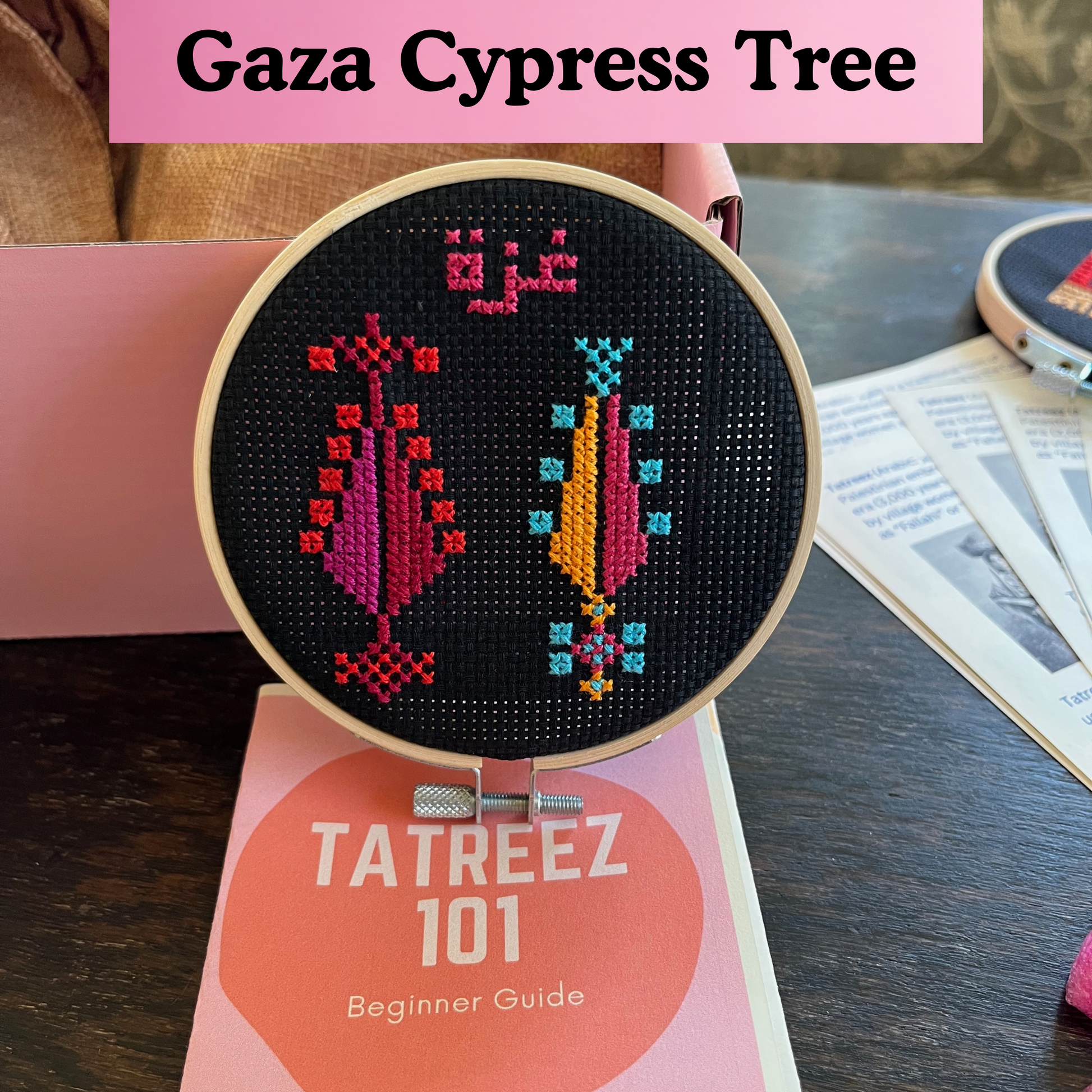 finished tatreez hoop kit with gaza trees design on black aida cloth. view from the front