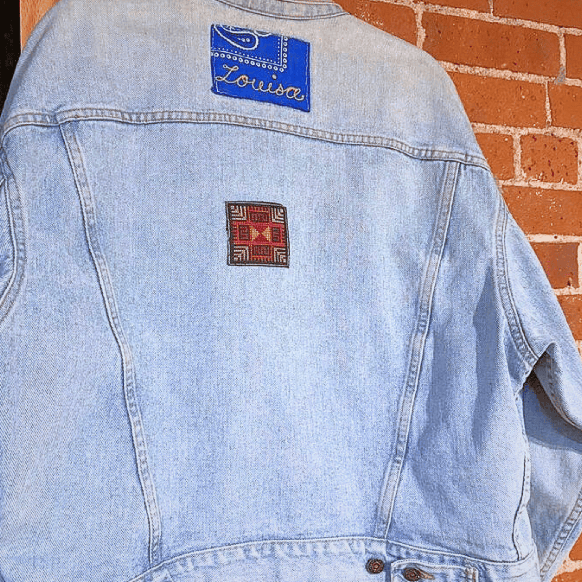 Tatreez kit with moon with feathers Palestinian tatreez design. black aida cloth, sewed onto a denim jacket, view from the front