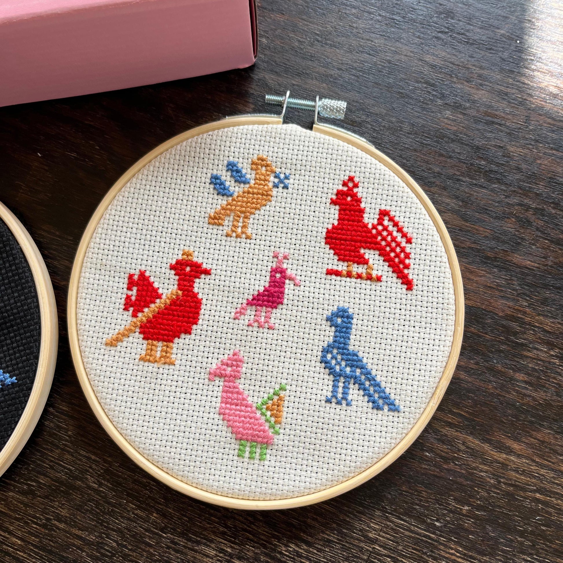 Tatreez kit with birds of Ramallah design. white aida cloth in embroidery hoop. view from above